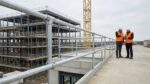 Modular tubular steel handrail and clamp fittings on a modern construction site