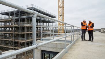 Modular tubular steel handrail and clamp fittings on a modern construction site