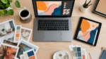 Overhead flat lay of a freelance designer's desk with laptop and design mockup, representing higher value creative project work